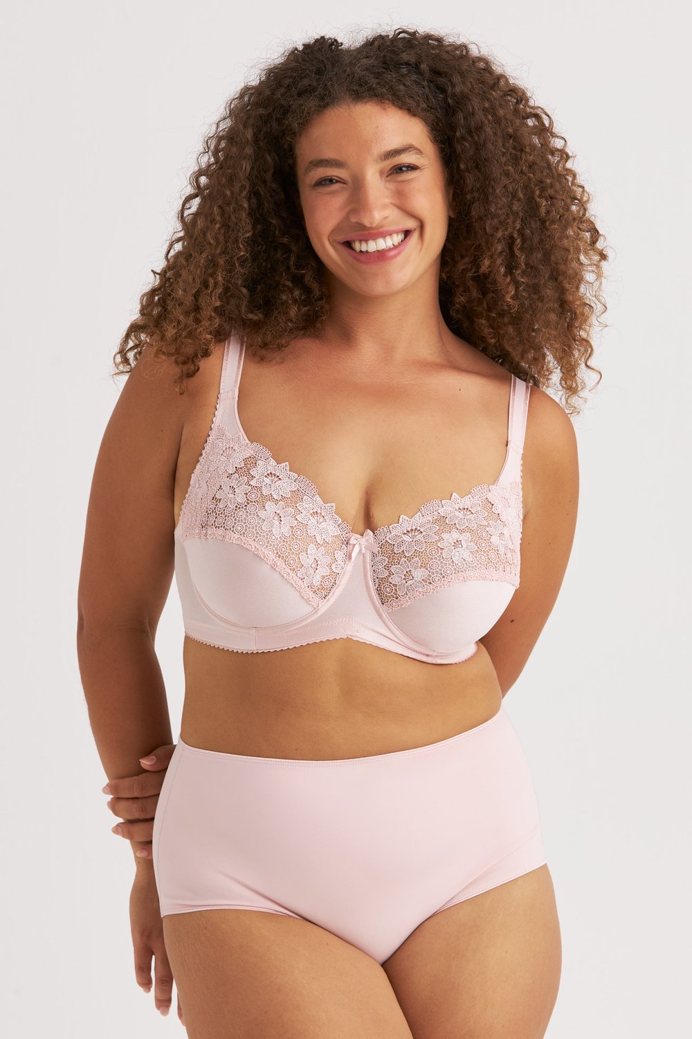 Femme souriante portant le soutien-gorge avec armatures vieux rose Summer de Miss Mary à broderie de guipure.