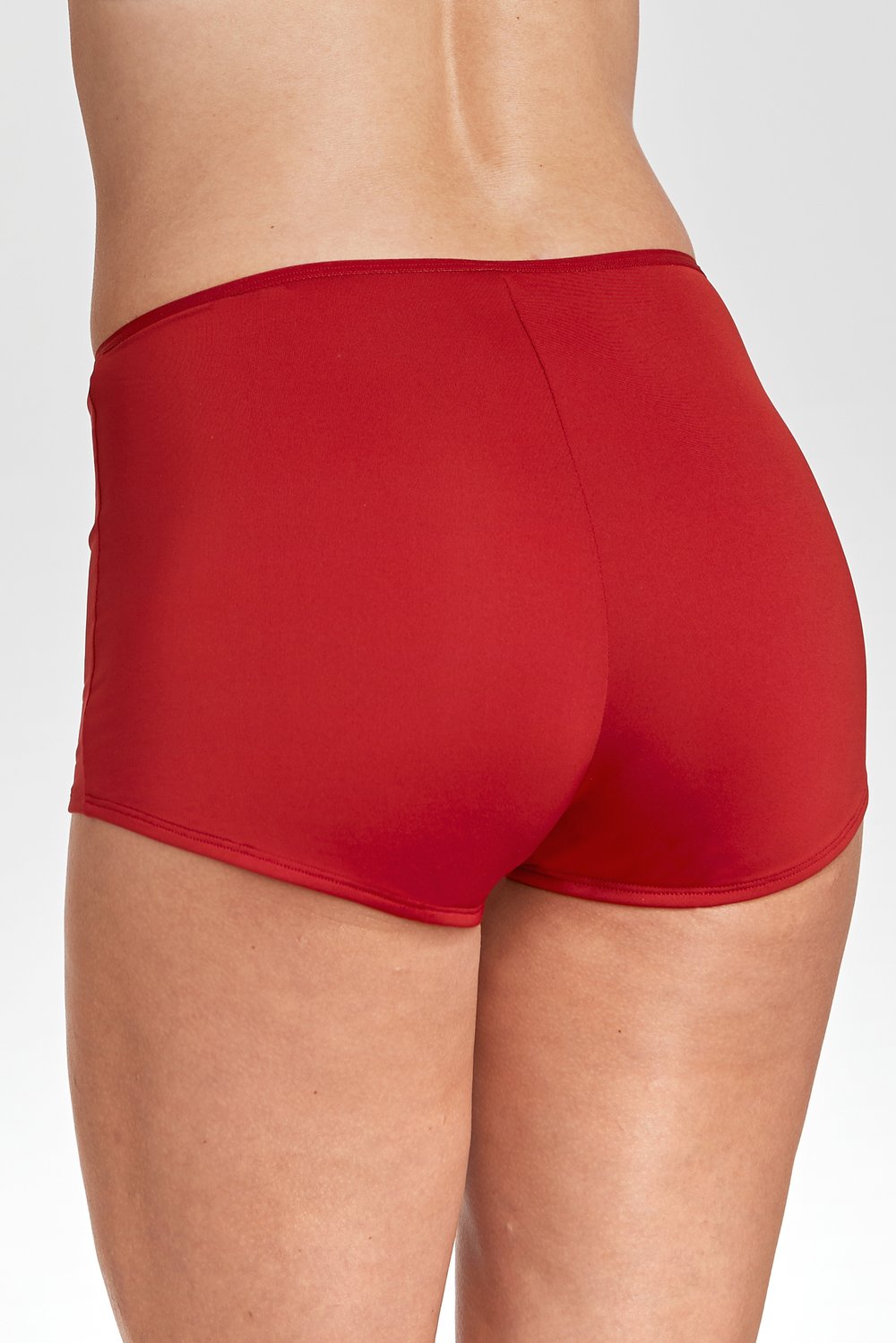 Back view of a woman wearing red, high-waisted cotton boxer panties by Miss Mary.