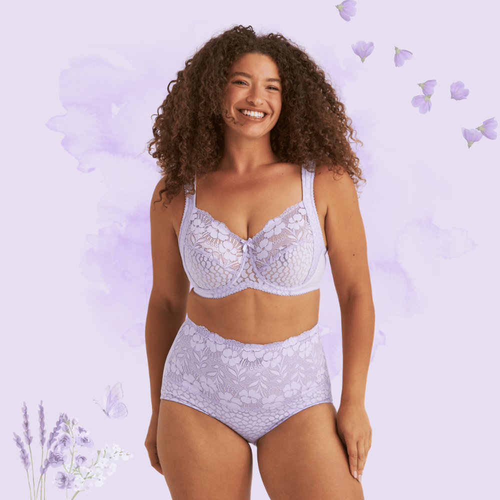 Smiling woman wearing lavender lace lingerie against a purple floral background with butterflies and flower illustrations.