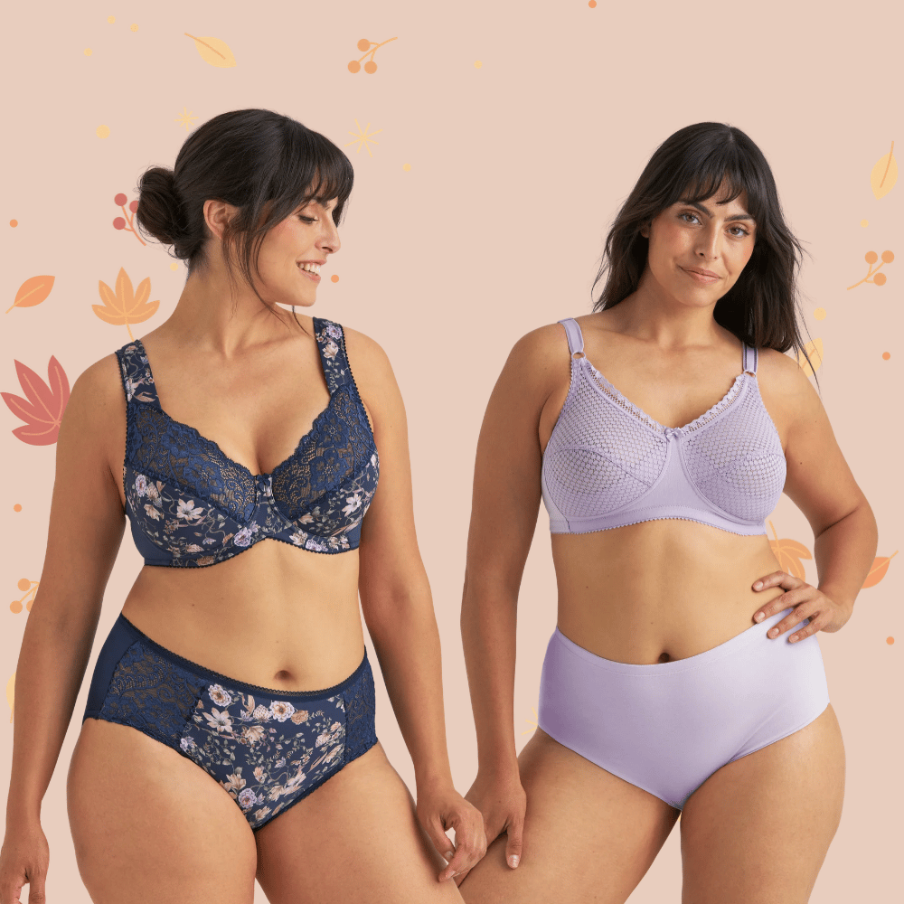 Two women wearing different lingerie sets, one in floral navy and the other in lilac, standing against a soft pink background with leaf motifs.