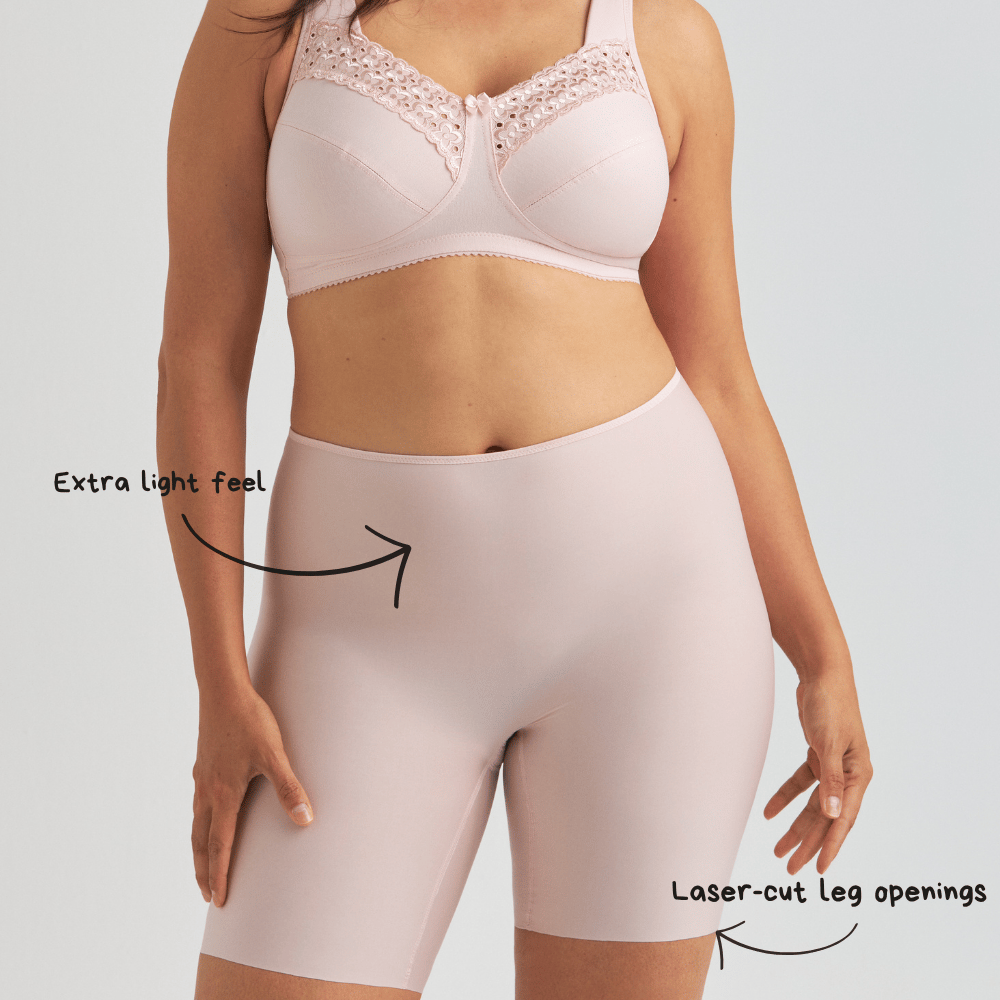 Person wearing a light pink bra and high-waisted shorts with notes indicating an extra light feel and laser-cut leg openings.