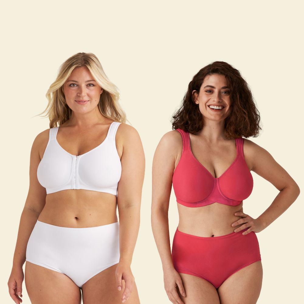 Two women smiling, wearing matching sets of underwear; one in white and the other in red, standing against a light background.