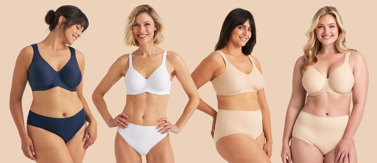 Four women of diverse body types wearing comfortable bras and panties in navy, white, and beige, smiling in front of a neutral background.