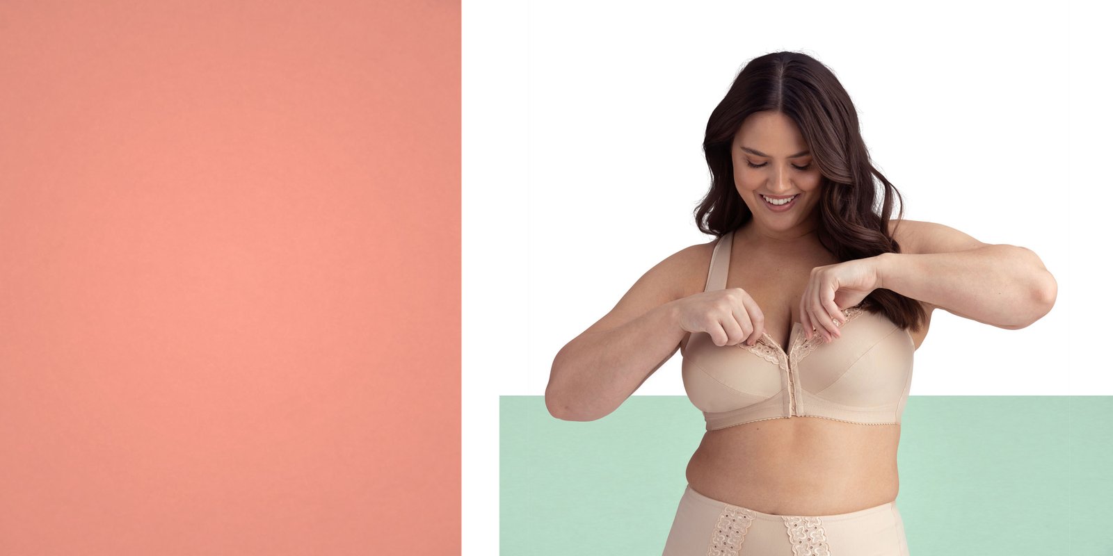 Smiling woman in beige lingerie adjusts her bra, standing against a color-blocked background of coral, white, and mint green.